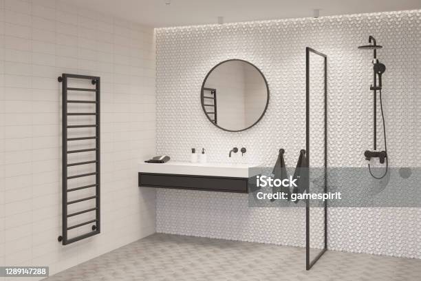 A Bright Bathroom With A Round Mirror Over A Black And White Washbasin With Two Terry Towels A Glass Partition A Shower A Black Heated Towel Rail Stock Photo - Download Image Now