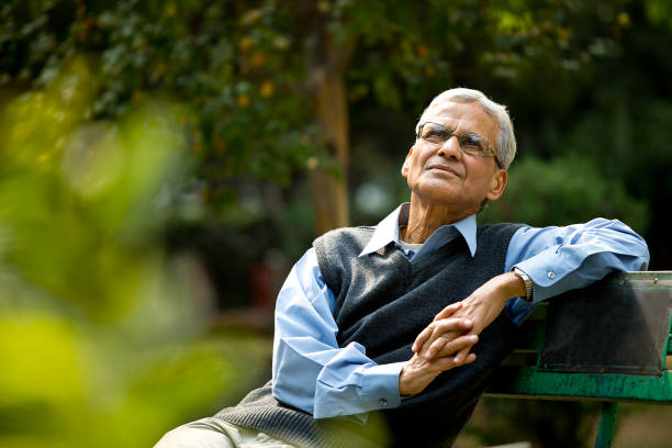 thoughtful senior man at park - portrait men senior adult depression imagens e fotografias de stock