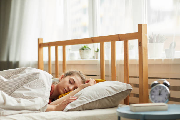istock Woman sleeping in bedroom 1289147691