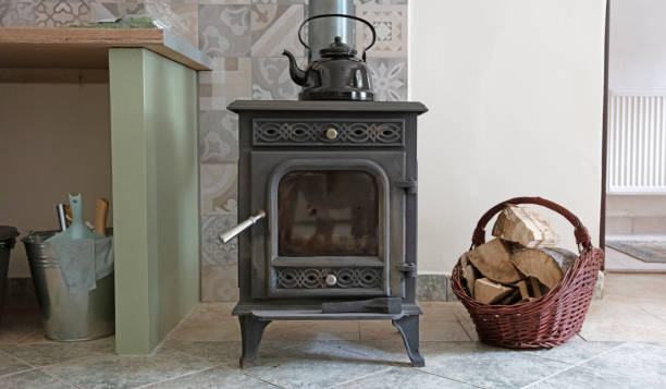 istock Small iron stove with straw basket, small house 1289148320