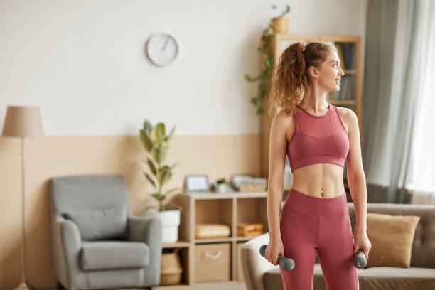 istock Woman exercising with dumbbells 1289148479