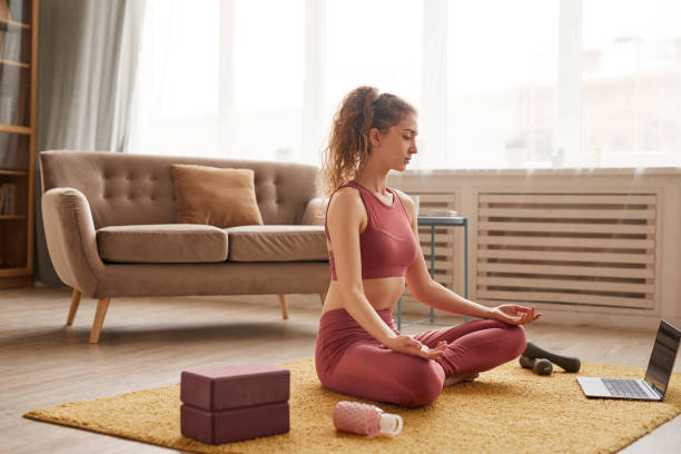 istock Woman meditating online 1289148713
