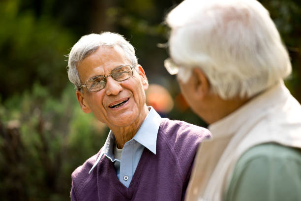 istock Two senior men discussing on park bench 1289149750
