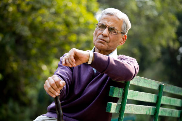 istock Senior man looking at wristwatch at park 1289151288