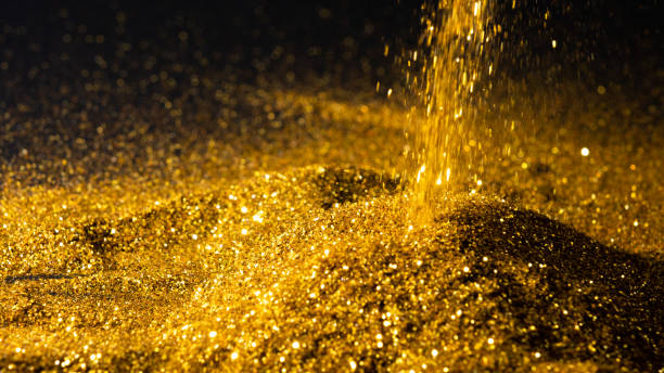 istock Sprinkle the glittering gold powder on the ground and black background 1289152122