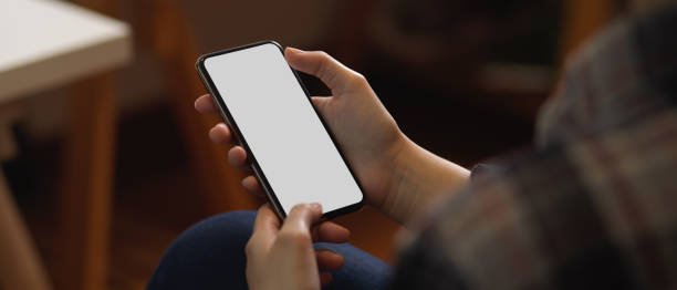 istock Female using smartphone in blurred office room background 1289154346
