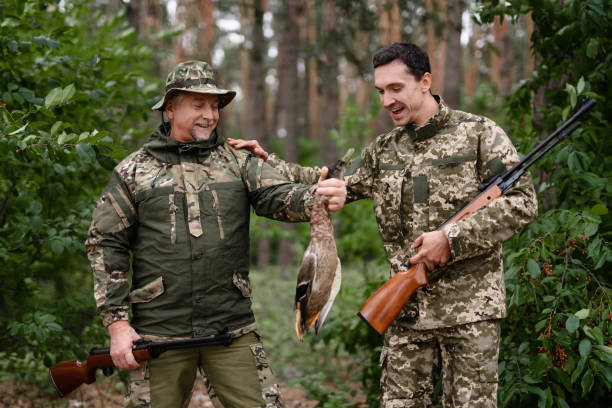 istock Two Men Enjoy Mallard Hunt in Summer Forest. 1289157009