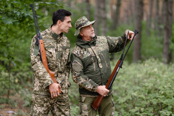 istock Game Bird Hunt Young and Old Men Discuss Weapon. 1289157052