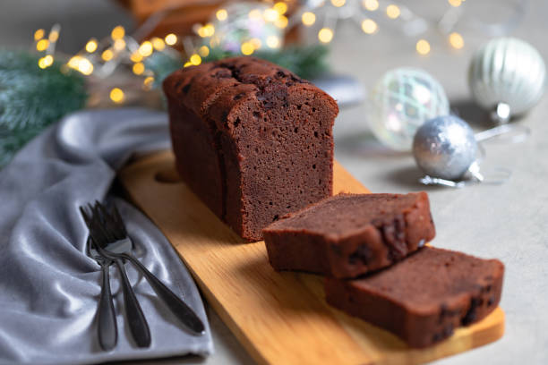 Slices of chocolate cake on gray Christmas table.