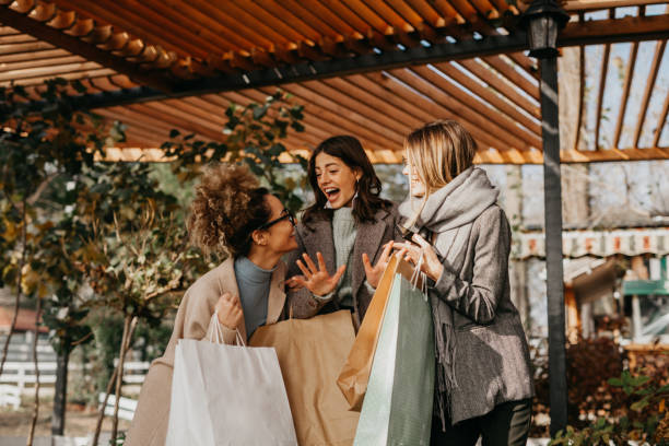 istock Girls gossip while shopping 1289160003