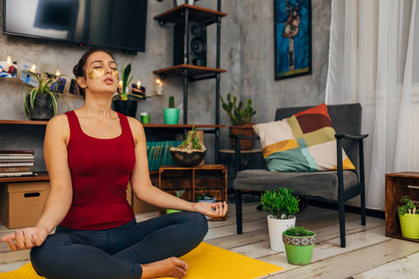 istock Active serene young woman doing yoga in her modern cozy home 1289160936