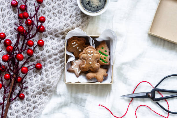 istock Gingerbread cookies in a box and a cup of coffee on a bedspread 1289161071
