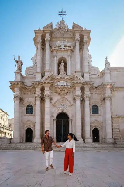 couple men and woman on citytrip, Ortigia in Syracuse Sicily Italy in the Morning. Travel Photography from Syracuse, Italy on the island of Sicily.
