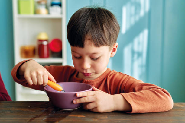 istock Cute children eating corn flakes with milk for breakfast 1289162283