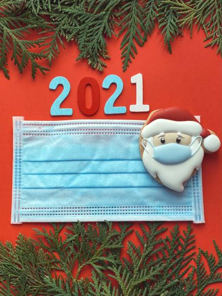 istock Blue protective face mask on Christmas decorations background. Christmas lockdown. 1289162405