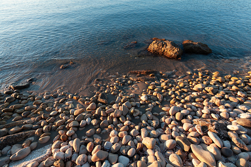 Pebble and seawater. Coast of Zakynthos island, Greece