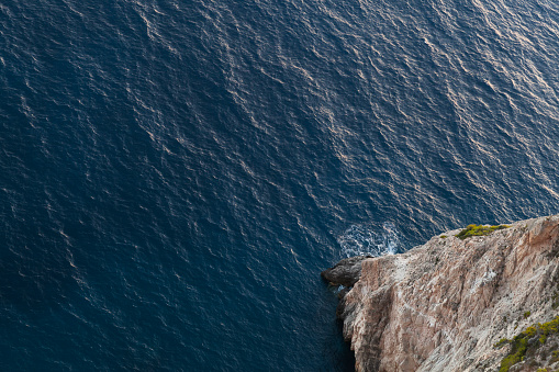 High cliff and sea water, top view. Rocky coast of Zakynthos island, Greece