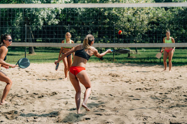 istock Female Friends Playing Beach Tennis 1289165037