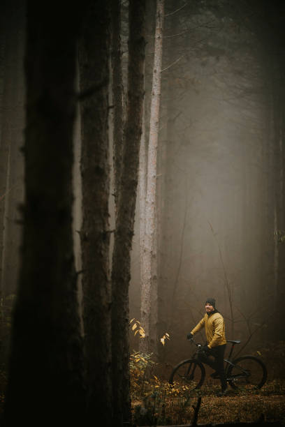 istock Young man taking a brake during biking through autumn forest 1289165084
