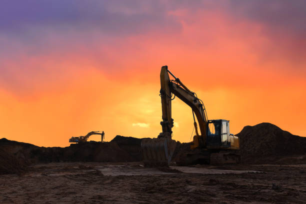 istock Excavator working on earthmoving at open pit mining on amazing sunset background 1289165410