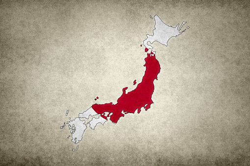 Grunge map of Japan with its flag printed within its border on an old paper.