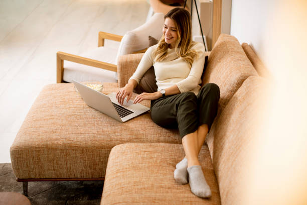 istock Young beautiful woman using a laptop at home 1289166622