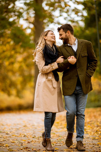 istock Young couple walking in the autumn park 1289166668