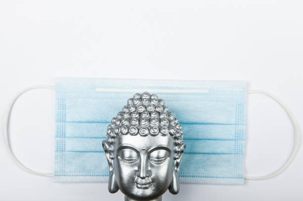 istock image of buddha mask white background 1289167890