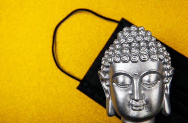 istock image of buddha mask gold background 1289167983