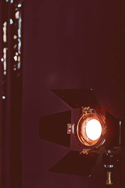 istock Studio lighting spotlight. Warm stage spotlight shines on dark background 1289169038