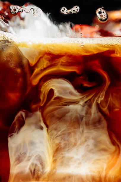 istock Cream being poured Into iced coffee. 1289170256