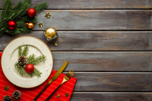 istock Frame of Christmas table setting with fir tree and empty plate, top view 1289171637