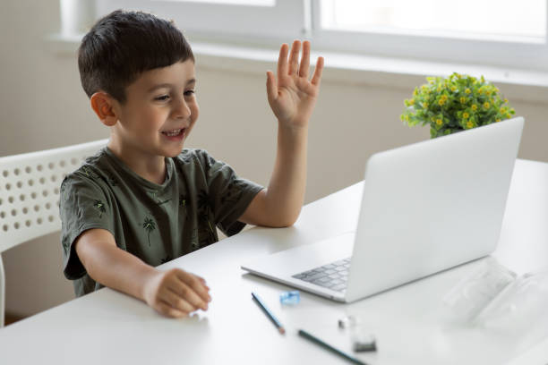 istock Little boy attending to online class from hom 1289172980