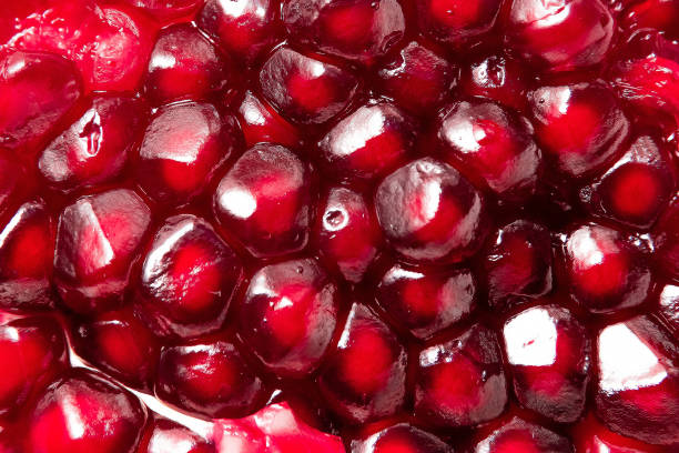 istock fresh pomegranate seeds macro close up in drops 1289176788