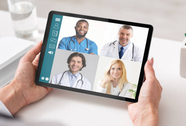 istock Woman With Tablet Having Consultation With Doctors Via Video Call 1289176848
