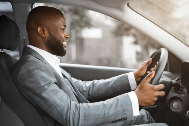 istock Joyful black businessman driving home after working day 1289177375