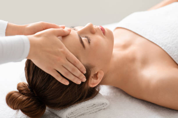 istock Spa attendant making healing head massage for young beautiful woman 1289178265