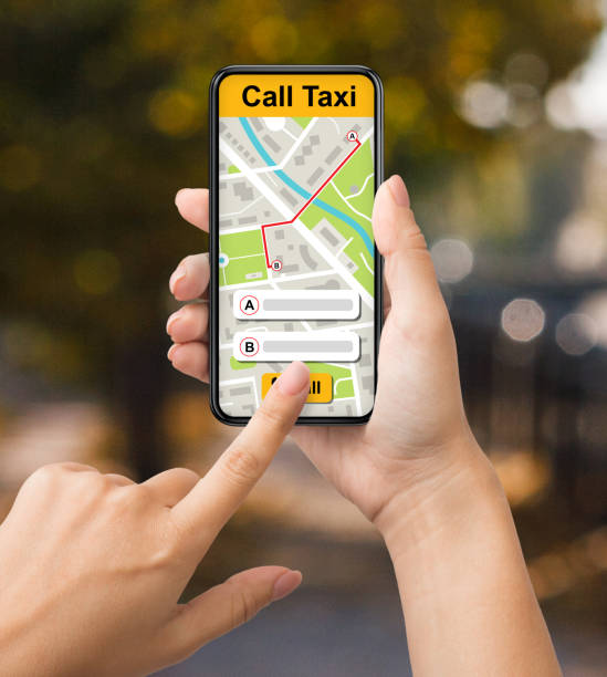 istock Lady holding smartphone with taxi app interface 1289178386