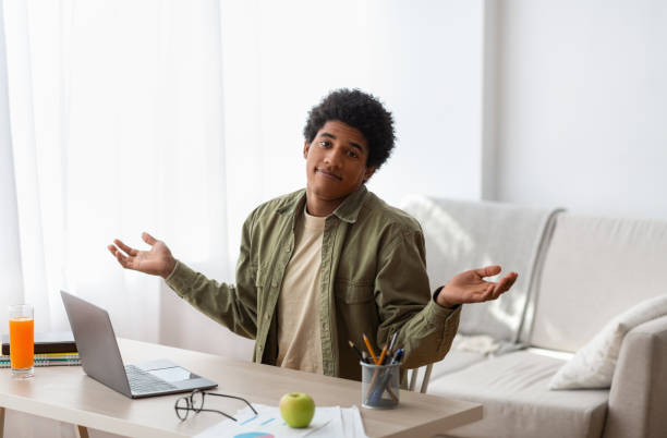 istock Puzzled black student sitting in front of laptop, not understanding difficult lesson, having difficulty studying online 1289178435