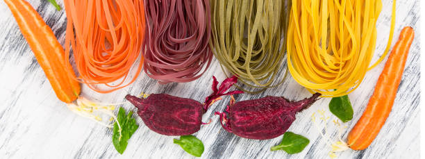 istock Banner of Colored Raw Vegetable Vegetarian Pasta. 1289178582