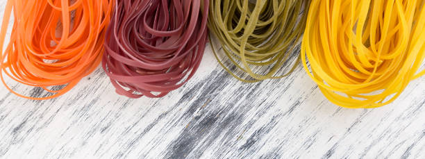 istock Banner of Colored Raw Vegetable Vegetarian Pasta. 1289178583