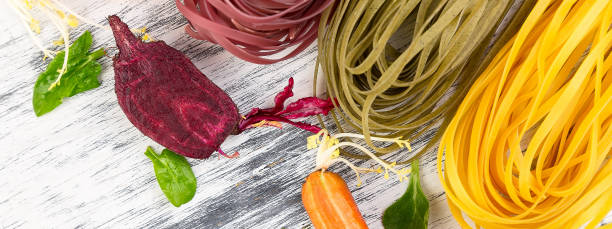 istock Banner of Colored Raw Vegetable Vegetarian Pasta. 1289178588
