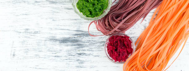 istock Banner of Colored Raw Vegetable Vegetarian Pasta. 1289178589