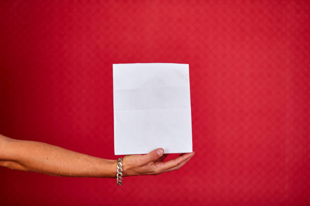 istock Closeup courier hand holding grocery paper bag, delivery service 1289178600