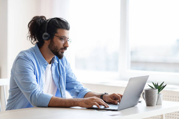 istock Handsome western freelancer guy working remotely with laptop at home office 1289178692