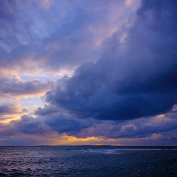 istock Storm clouds spiraling up over the Atlantic Ocean at sunset 1289179475