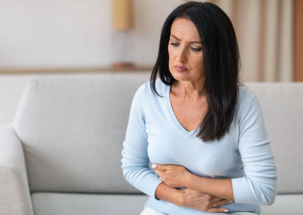 istock Mature Woman Suffering From Stomachache, Touching Belly 1289179602