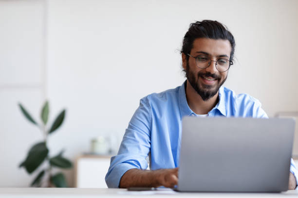 Recruitment Concept. Smiling Western Guy Using Laptop, Searching Jobs Online In Internet