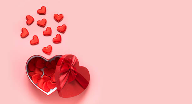 istock Valentine's Day concept with red boxes and hearts on pink. 1289179965