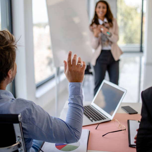istock Businessmen holding hand on presentation 1289181258